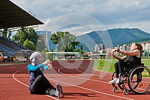 Two strong and inspiring women, one a Muslim wearing a burka and the other in a wheelchair stretching and preparing