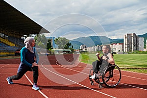 Two strong and inspiring women, one a Muslim wearing a burka and the other in a wheelchair stretching and preparing