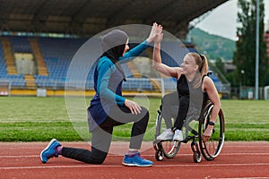 Two strong and inspiring women, one a Muslim wearing a burka and the other in a wheelchair stretching and preparing