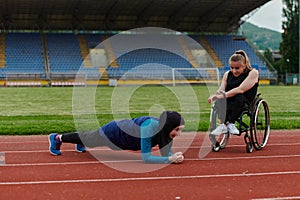 Two strong and inspiring women, one a Muslim wearing a burka and the other in a wheelchair stretching and preparing