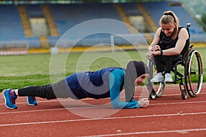 Two strong and inspiring women, one a Muslim wearing a burka and the other in a wheelchair stretching and preparing