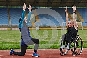 Two strong and inspiring women, one a Muslim wearing a burka and the other in a wheelchair stretching and preparing