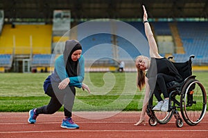 Two strong and inspiring women, one a Muslim wearing a burka and the other in a wheelchair stretching and preparing