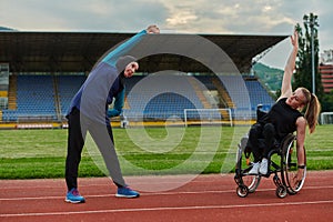 Two strong and inspiring women, one a Muslim wearing a burka and the other in a wheelchair stretching and preparing