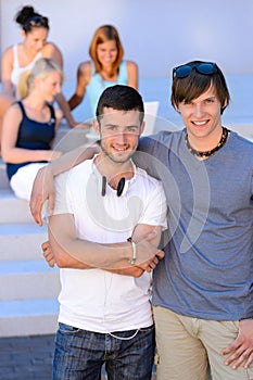 Two student boys standing outside college summer