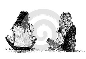 Two student girls sitting on the lawn in a city park