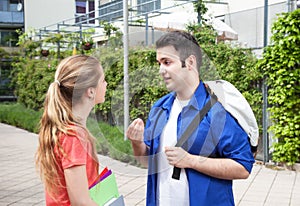 Two students on campus speaking about the studies