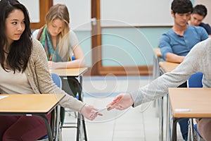 Two students cheating in the classroom