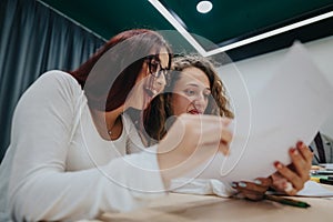 Two students collaborating on academic work in a classroom setting