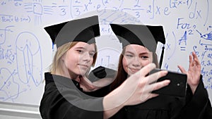 Two students make photo on phone in university.