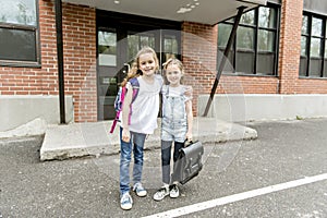 Two students outside at school standing together