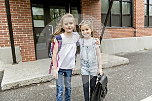 Two students outside at school standing together