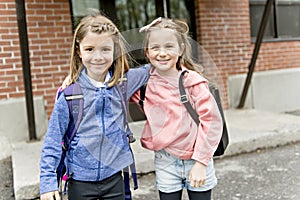 Two students outside at school standing together