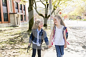 Two students outside at school standing together