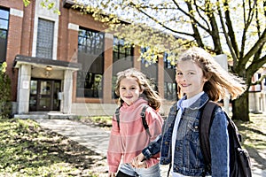 Two students outside at school standing together