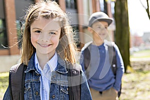 Two students outside at school standing together