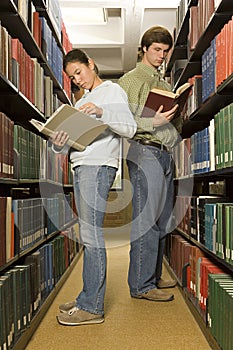 Two students reading in the library