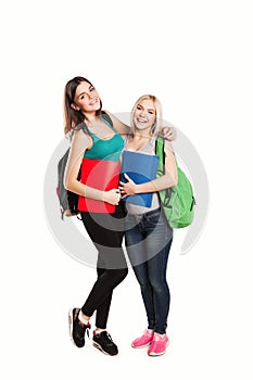 Two students with school bags posing isolated on