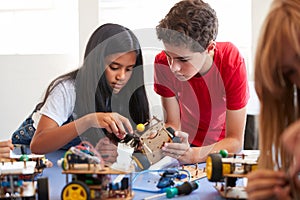 Two Students In After School Computer Coding Class Building And Learning To Program Robot Vehicle