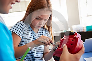 Two Students In After School Computer Coding Class Learning To Program Robot Vehicle