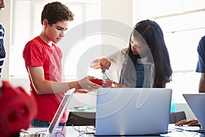Two Students In After School Computer Coding Class Learning To Program Robot Vehicle