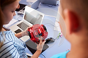 Two Students In After School Computer Coding Class Learning To Program Robot Vehicle