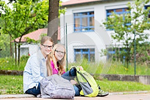 Two students sitting at school in recess