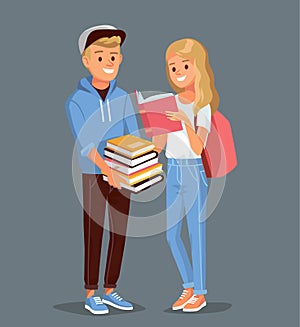 Two students standing together holding books