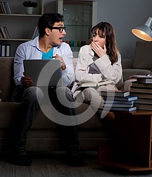 Two students studying late preparing for exams