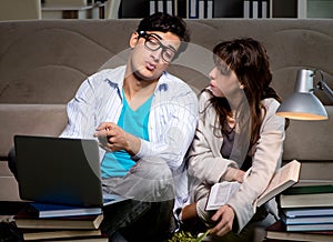 Two students studying late preparing for exams