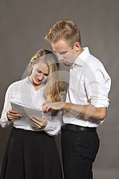 Two students young man and woman watching papers