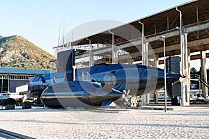 Two submarines. A small and large black submarine mounted on land in a museum in the city of Tivat, in the Porto Area of