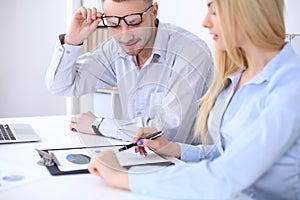 Two successful business partners working at meeting in office