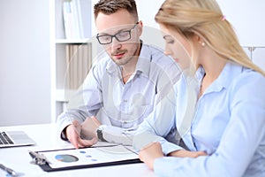 Two successful business partners working at meeting in office