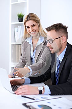 Two successful business partners working at meeting in office