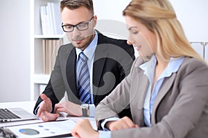 Two successful business partners working at meeting in office