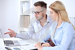 Two successful business partners working at meeting in office