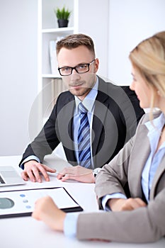 Two successful business partners working at meeting in office