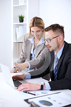 Two successful business partners working at meeting in office