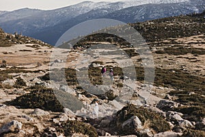 Two successful hiker woman friends enjoy the view on mountain peak. Happy backpackers walking in nature