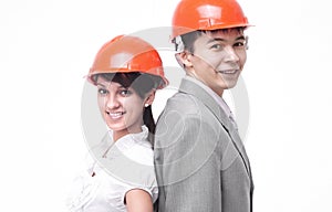 Two successful young architect standing back to back. isolated on a white background