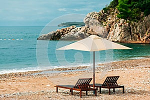 Two sunbeds and umbrella at luxury beach resort