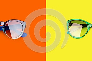 Two sunglasses yellow orange red background closeup top view fashion man and woman sunshades