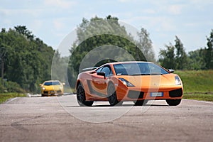 Two supercars on a racetrack