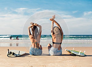 Two surfer girls at the beach