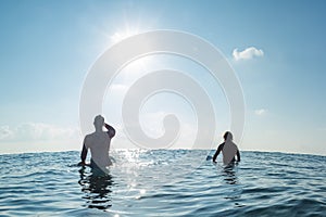 Two surfers wait the wave