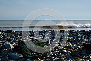 two surfers waiting for cold water waves abstract bohkeh foreground