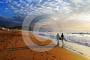 Two surfers walking on Sopelana beach