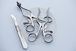 Two surgical retractors and scalpel