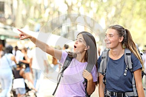 Backpackers sightseeing in the street finding landmark photo